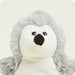 Plush toy with a white face and gray fur on a light gray background