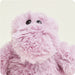 Pink fluffy toy with black eyes on a light pink background