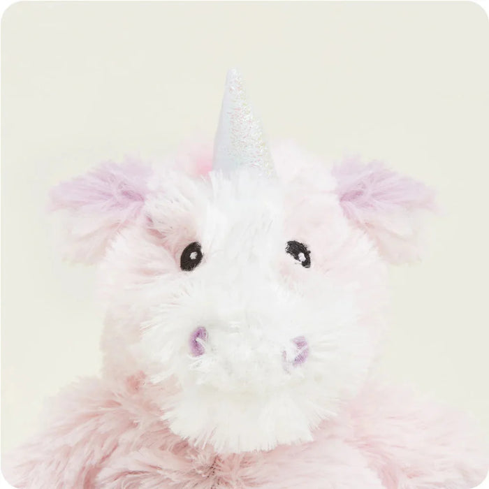 Plush toy resembling a unicorn with pink and white colors on a light background