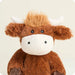 Plush toy cow with a white face and brown body on a light beige background