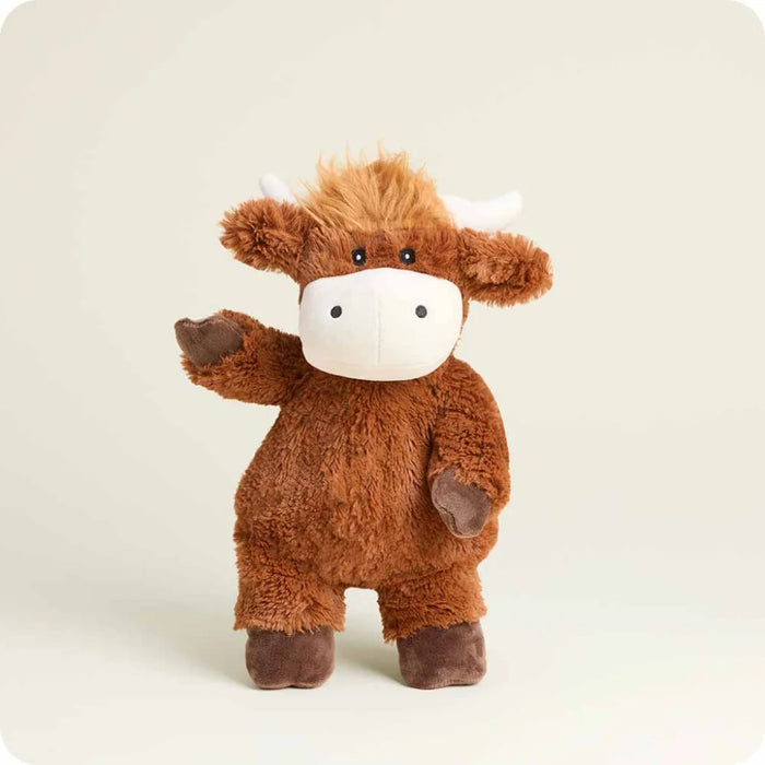 Plush toy cow on a light beige background
