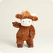 Plush toy cow on a light beige background