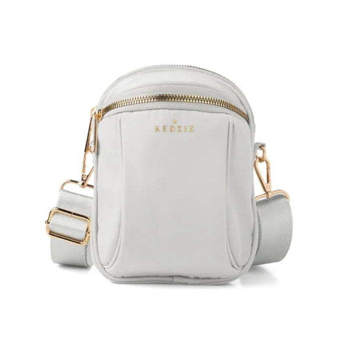 Light gray crossbody bag with gold accents on a white background