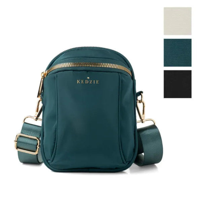 Teal crossbody bag with gold zippers and accents on a white background, featuring the brand 'KEDZIE'.