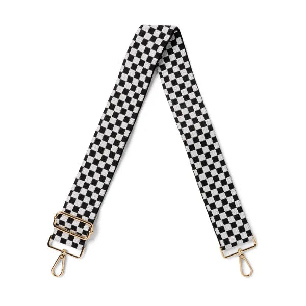 Black and white checkered bag strap with gold hardware on a white background