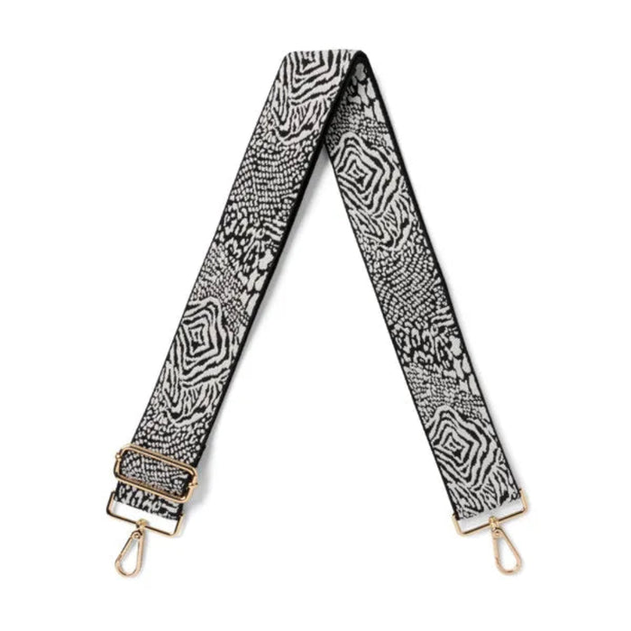 Patterned strap with gold hardware on a white background