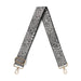 Patterned strap with gold hardware on a white background