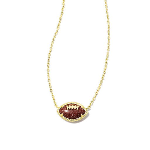 Close-up of Kendra Scott football pendant necklace featuring orange goldstone football set in gold
