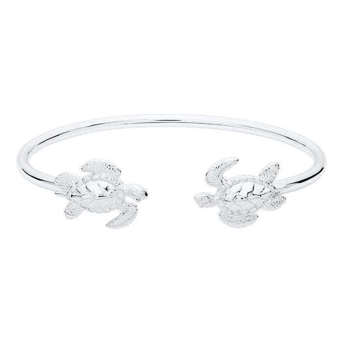 Pair of silver turtle-shaped bangles on a white background