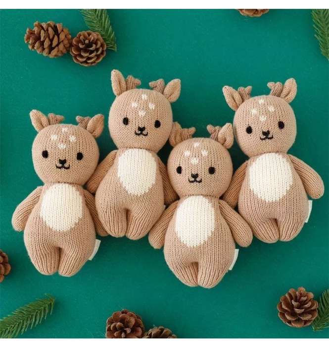 Cuddle + Kind Baby Fawn dolls – set of four handmade knit stuffed deer toys with pinecones and greenery.