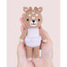 Tiny Violet the Fawn by Cuddle + Kind, small size hand-knit doll held in adult hands.