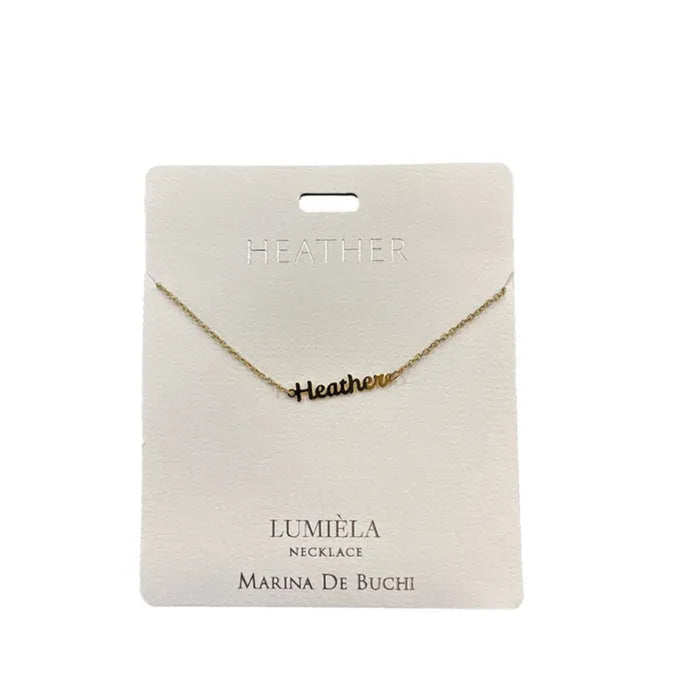 Gold necklace on a 'HEATHER' branded card with Lumiéla and Marina De Buchi branding.