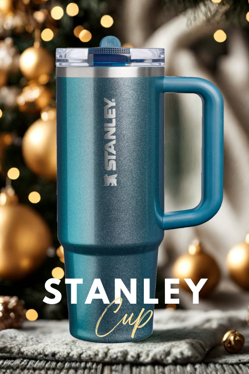 Blue Stanley mug with a Christmas tree in the background
