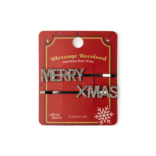 Holiday hair pins with 'Merry XMAS' text on a red packaging card.
