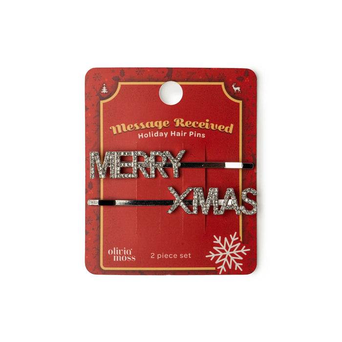 Holiday hair pins with 'Merry XMAS' text on a red packaging card.