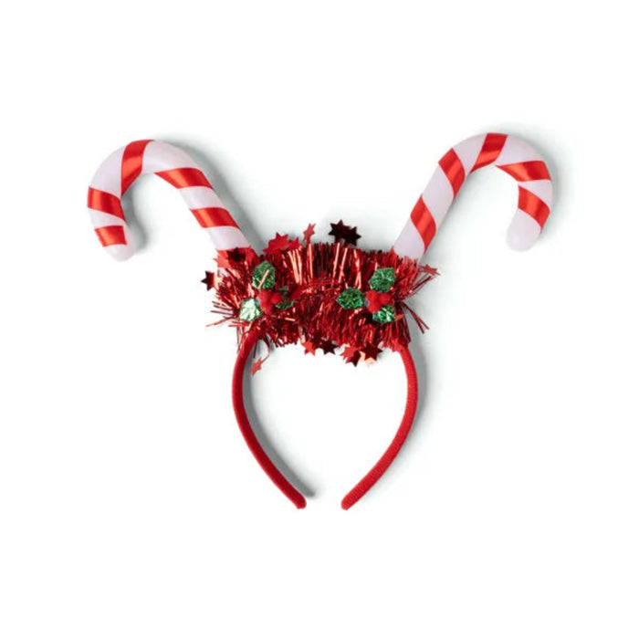 Red and white candy cane headband with festive decorations on a white background