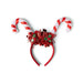 Red and white candy cane headband with festive decorations on a white background