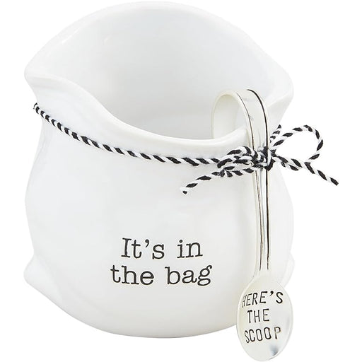 Mud Pie Candy Bag with Scoop featuring a white ceramic bag-shaped container with “It’s in the bag” text and a silver scoop reading “Here’s the Scoop.”