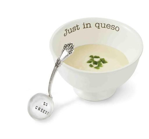 Mud Pie “Just In Queso” Dip Bowl filled with queso dip, garnished with diced jalapeños, and paired with a silver ladle that reads “So Cheesy.”