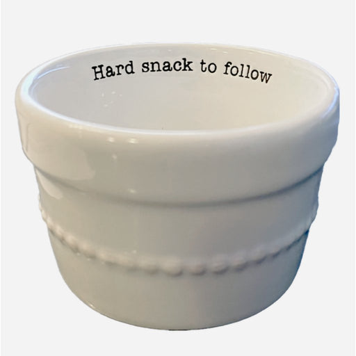 Mud Pie Hard Snack Ramekin Bowl — white ceramic bowl with beaded detailing and the phrase “Hard snack to follow” printed inside.