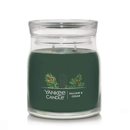 Yankee Candle Balsam & Cedar Signature Medium Jar with dark green wax and double wicks inside a clear glass jar.
