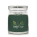 Yankee Candle Balsam & Cedar Signature Medium Jar with dark green wax and double wicks inside a clear glass jar.